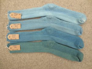 4 pairs of socks labelled forget me not, pale woad blue, stone blue, deep sea