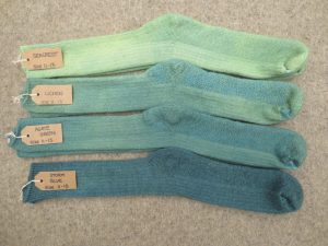 4 pairs of socks labelled seacrest, lichen, agate green, storm blue