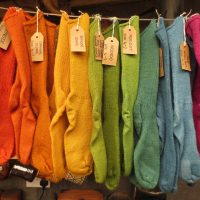 Hanging woolen socks in a rainbow of naturally dyed colours