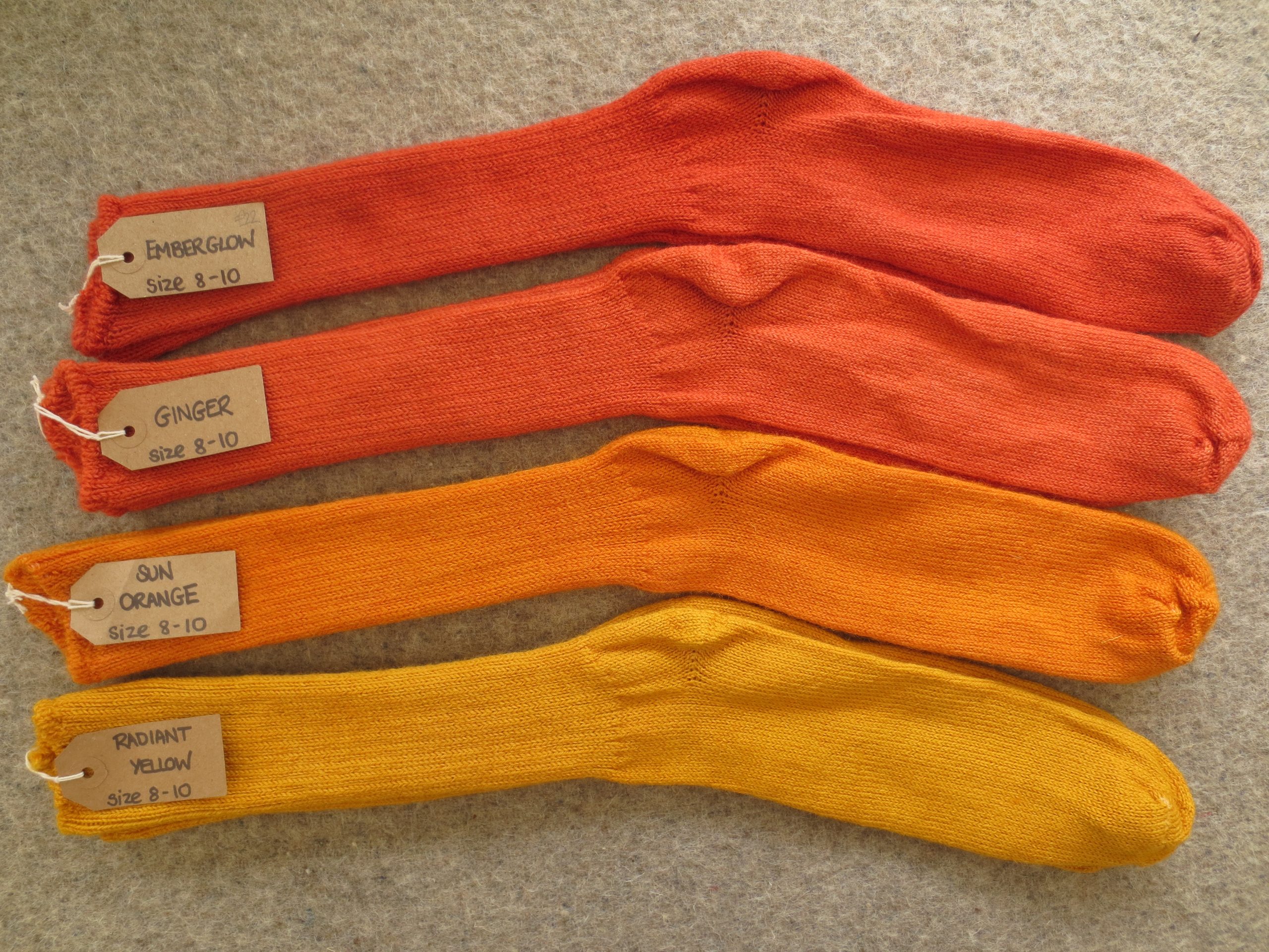 4 pairs of socks labelled Emberglow, Ginger, Sun Orange and Radiant Yellow
