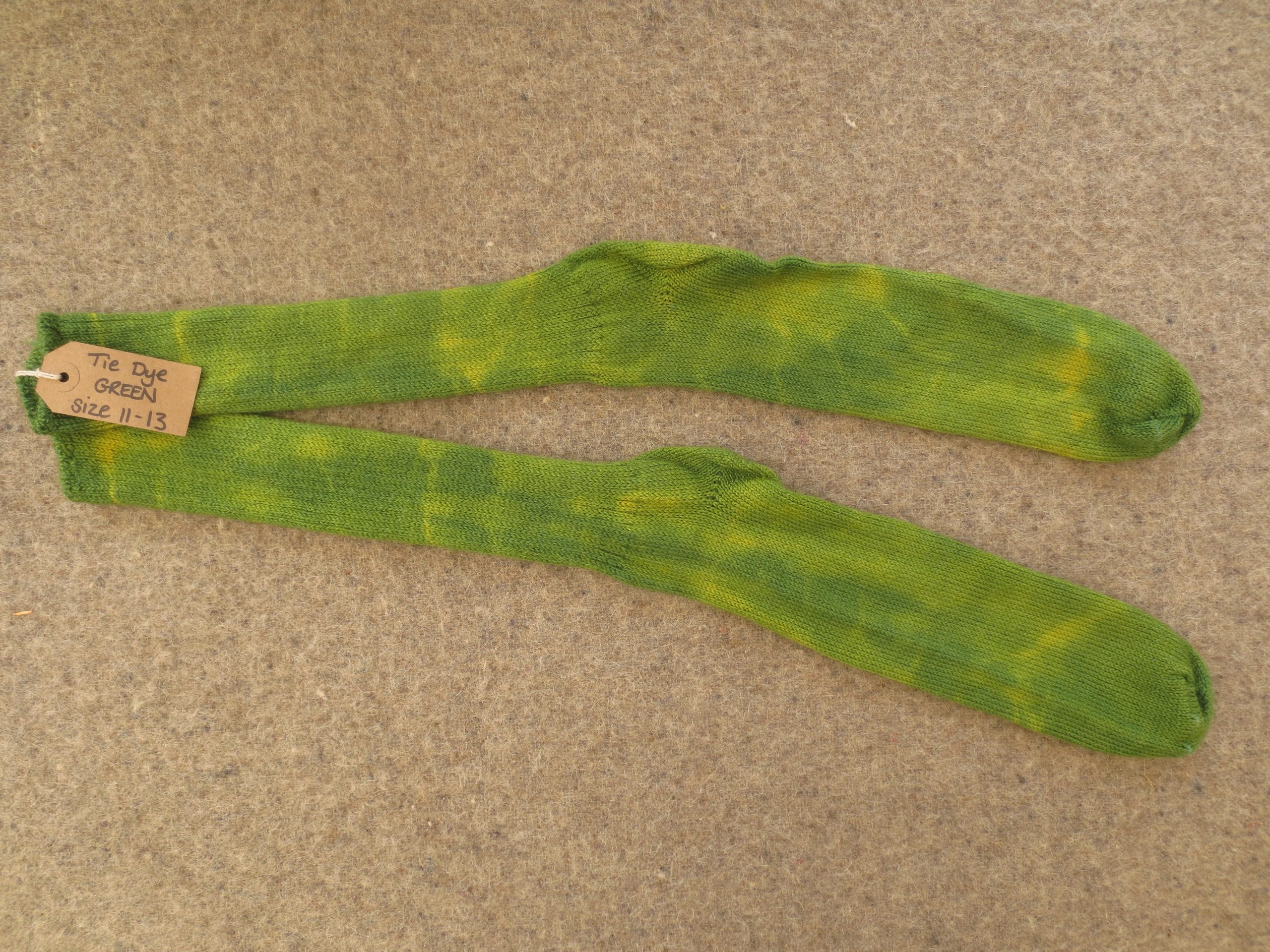 One pair of socks labelled tie dye green