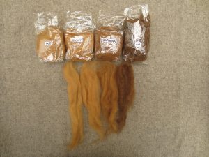 4 small bags of naturally dyed wool labelled doe, biscuit, chipmunk, cub