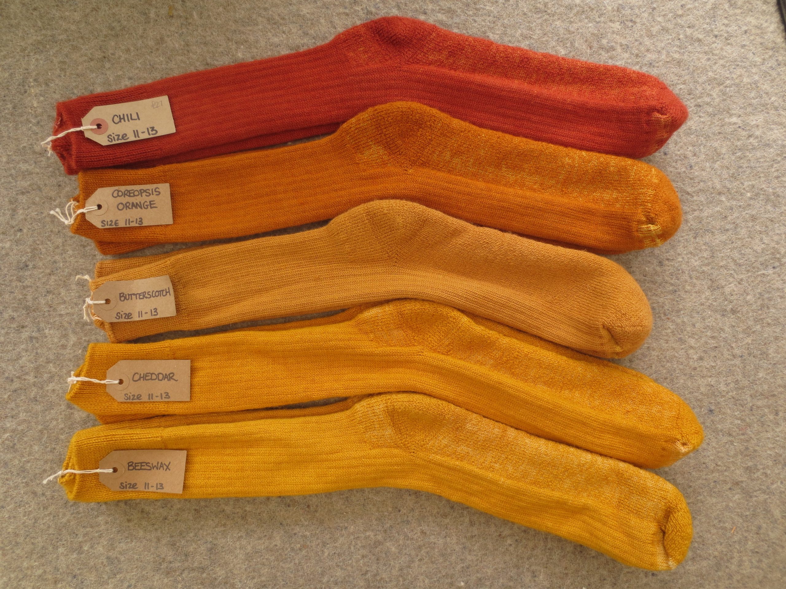5 pairs of socks labelled Chili, Coreopsis Orange, Butterscotch, Cheddar and Beeswax