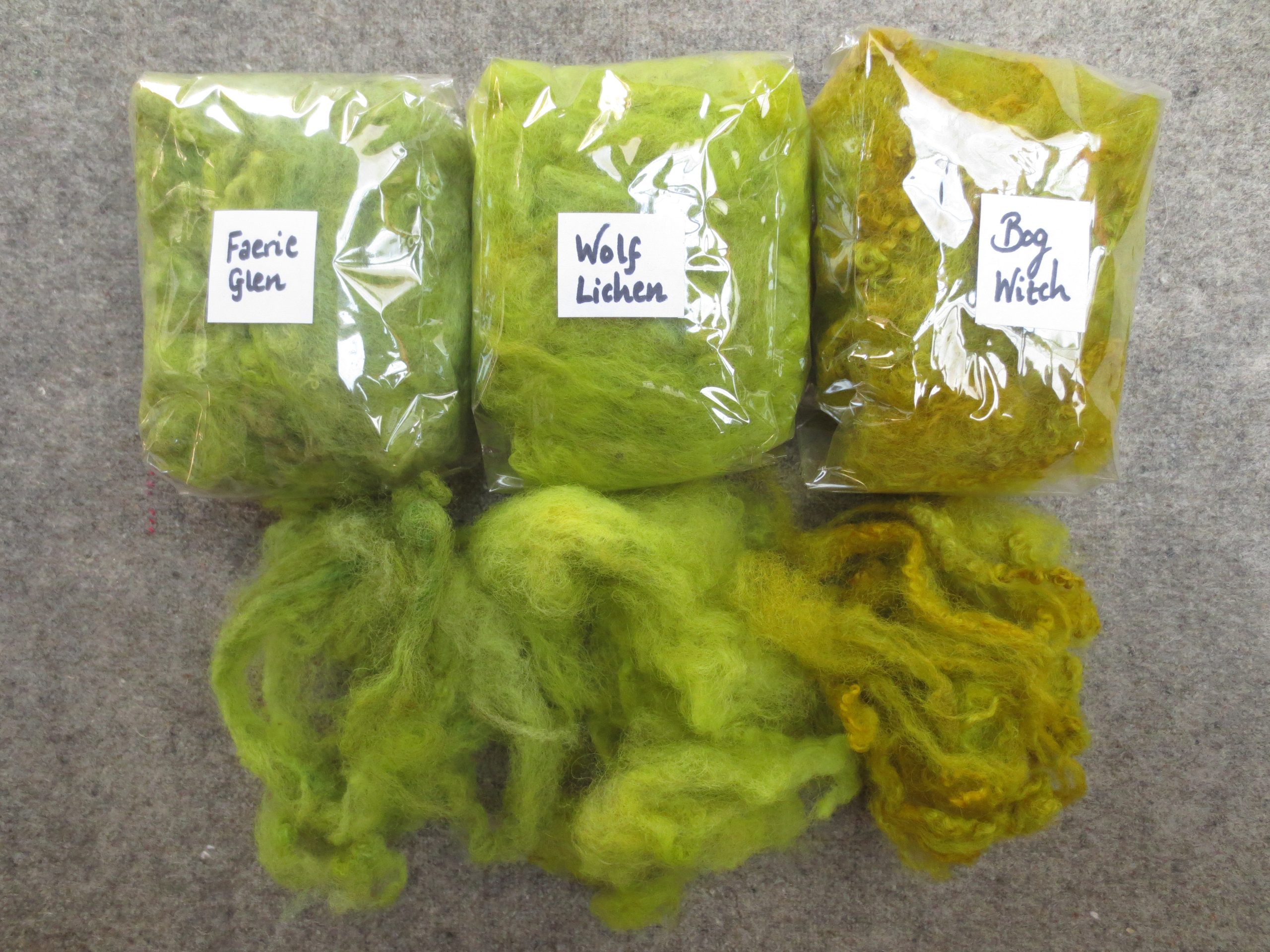 3 bags of wool with samples labelled faerie glen, wolf lichen and bog witch