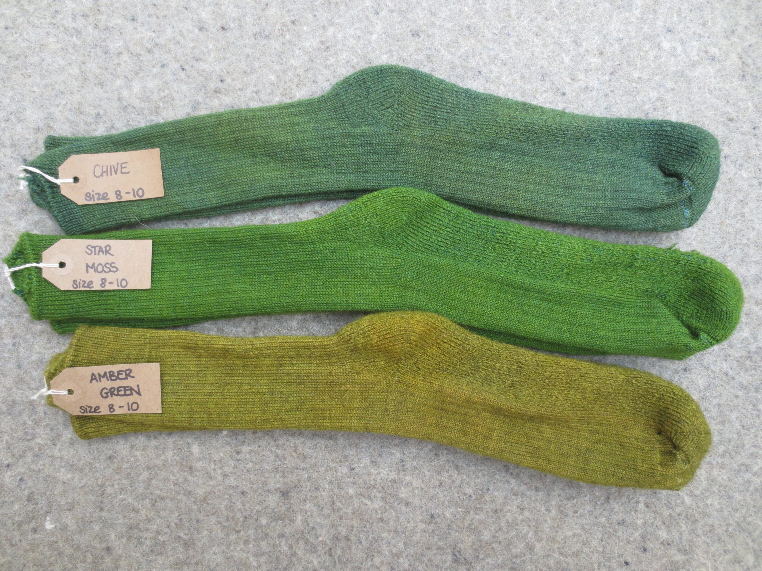 3 pairs of socks labelled Chive, Star Moss and Amber Green