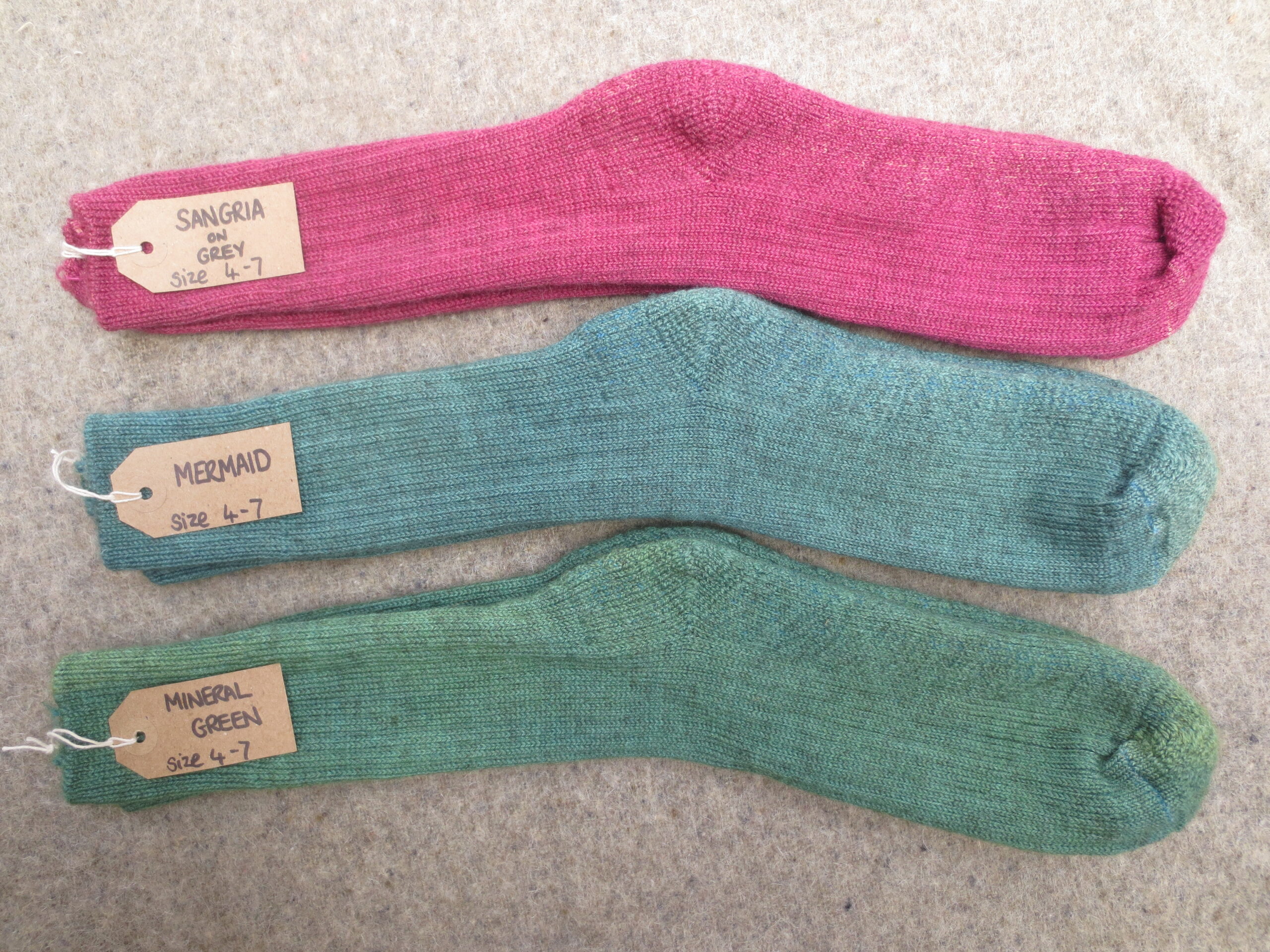 3 pairs of socks labelled Sangria on Grey, Mermaid and Mineral Green