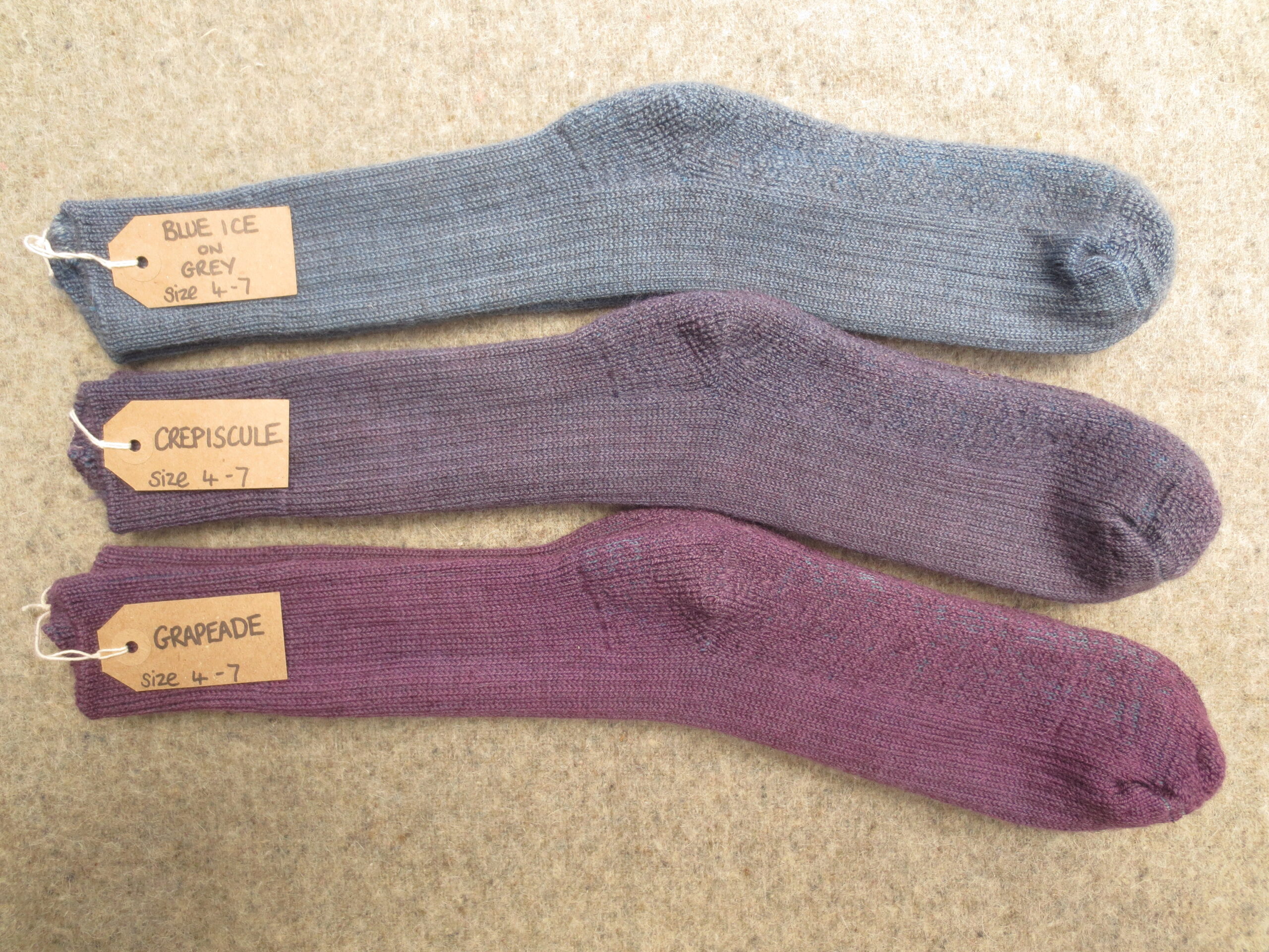 3 pairs of socks labelled Blue Ice on Grey, Crepiscule and Grapeade